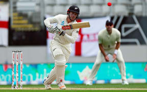Henry Nicholls bats during the day-night, pink ball cricket test match at Eden Park in Auckland.