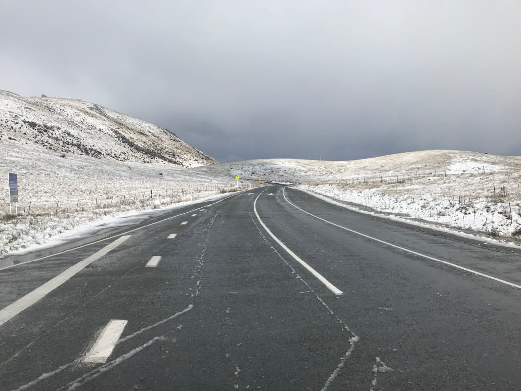 Snow covers hills near Lake Tekapo.