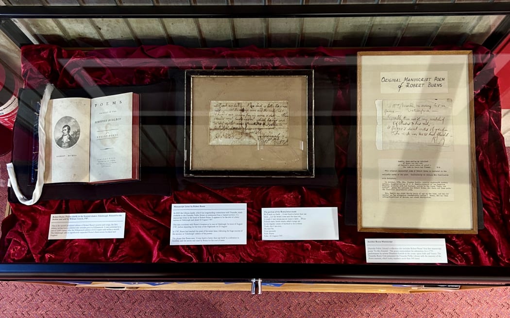 The framed Robert Burns manuscript segment is on display at Dunedin City Library