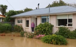 June Gillanders’ house in Tai Tapu is surrounded by water from the Halswell River after heavy rain on 1 May in Canterbury.