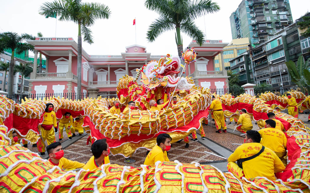 People perform a dragon dance to celebrate the Chinese Lunar New Year in Macao, south China, 1 February 2022.