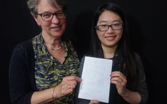 Eva Radich with Chunxaio Lu showing off her Chinese language notes.