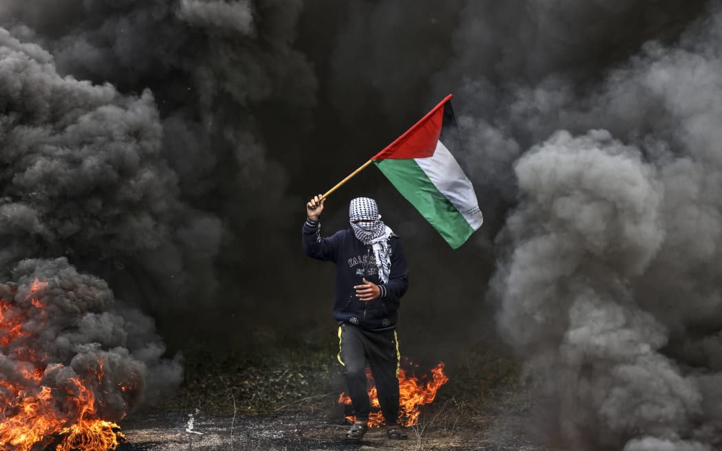 Palestinian youths burn tyres during a protest near the Israel-Gaza border east of Jabalia refugee camp, 23 February 2023.