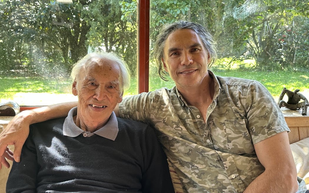 Brett & Fred Graham sit next to each other in their home.