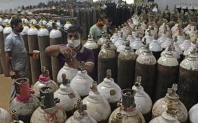 Workers arrange medical oxygen cylinders to be transported to hospitals amid Covid-19 coronavirus pandemic at a facility on the outskirts of Chennai on April 24, 2021.