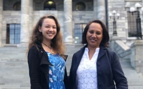 Journalist Tiana Haxton (left) from the Cook Islands and journalist Esther Pavihi from Niue stand outside Parliament House in Wellington.