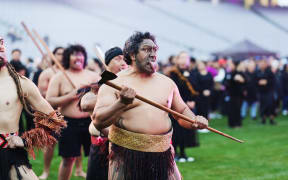 One of the participants does a pūkana.