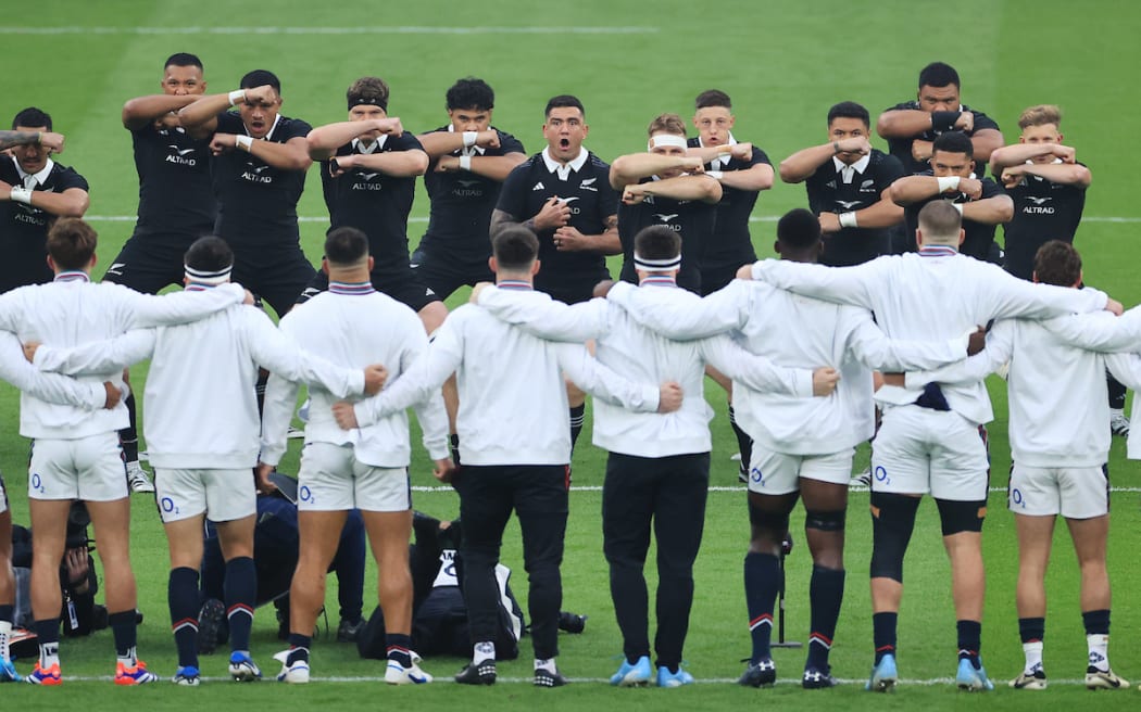 England players approach the New Zealand team as they perform the Haka.