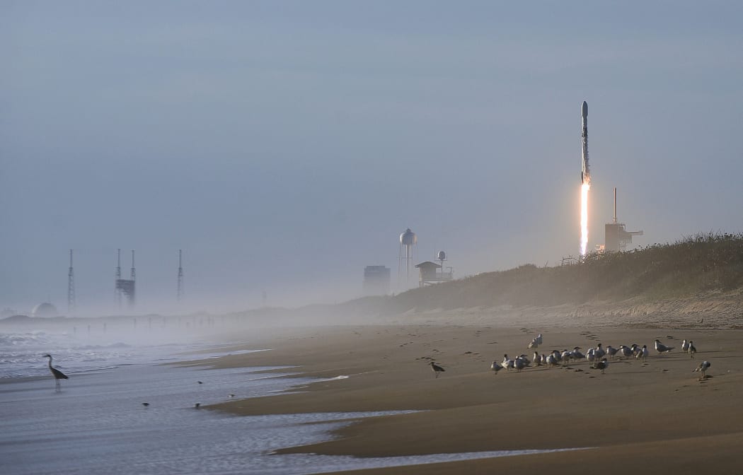 A SpaceX Falcon 9 rocket carrying 60 Starlink satellites forms a vapor cone after launching from pad 39A at the Kennedy Space Center in Florida in March.