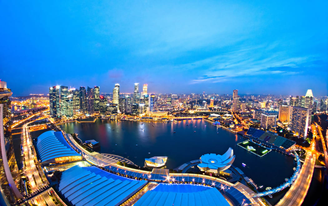 19628987 - fish-eye view of singapore city skyline at sunset.