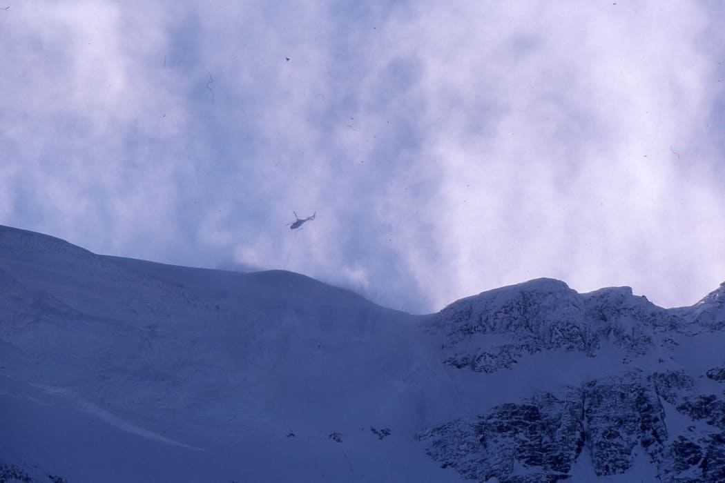 A photo of the rescue helicopter hovering above the mountain while Don Bogie is inside the ice cave known as 'Middle Peak Hotel'