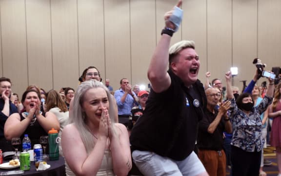 Abortion supporters Alie Utley and Joe Moyer (R) react to the failed constitutional amendment proposal at the Kansas Constitutional Freedom Primary Election Watch Party in Overland Park, Kansas on August 2, 2022. - Voters in the traditionally conservative state of Kansas voted Tuesday to maintain the right to abortion, in the first election on the flashpoint issue since the Supreme Court overturned Roe v. Wade in June, US media reported. 
In a significant win for the pro-access side of the US abortion debate, Kansans rejected an amendment that would have scrapped language in the state constitution guaranteeing the right to the procedure and could have paved the way for stricter regulations or a ban. (Photo by DAVE KAUP / AFP)
