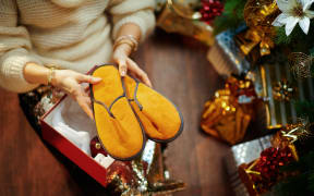 Christmas tree near present boxes, slippers.