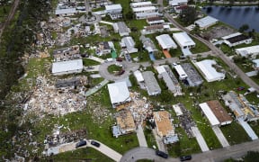 Aerial view of destroyed houses in Port St Lucie, Florida, after a tornado hit the area and caused severe damage as Hurricane Milton swept through Florida on October 11, 2024. - The death toll from Hurricane Milton rose to at least 16 on October 11, 2024, officials in Florida said, as residents began the painful process of piecing their lives and homes back together. Nearly 2.5 million households and businesses were still without power, and some areas in the path cut through the Sunshine State by the monster storm from the Gulf of Mexico to the Atlantic Ocean remained flooded. (Photo by Miguel J. Rodriguez Carrillo / AFP)