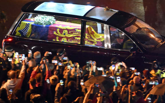 Seen from the top of the Wellington Arch, the coffin of Queen Elizabeth II is taken in the Royal Hearse to Buckingham Palace in London on September 13, 2022.