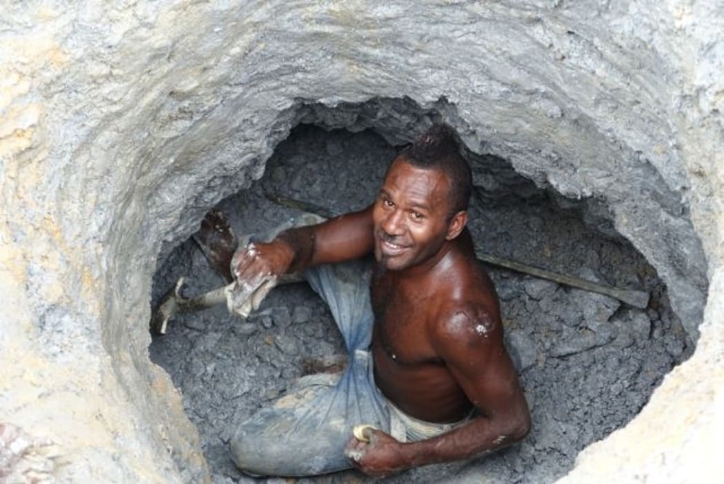 An artisinal gold miner from Nusuta village in Solomon Islands Guadalcanal Province digs for ore in Gold Ridge's pit 3 also known as Kupers.