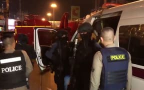 A video grab from a handout video released by the MCOT Thai Public Company Limited shows Thai police arriving at the scene of a mass shooting in the northeastern city of Nakhon Ratchasima.