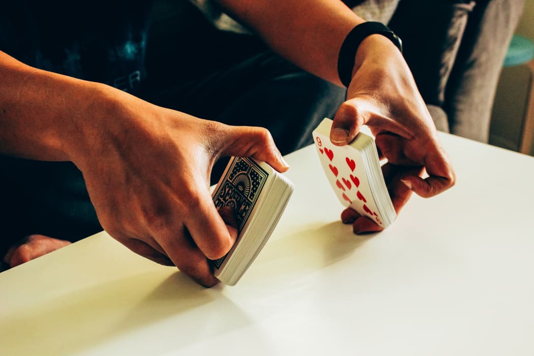person shuffling cards