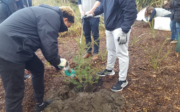 Christchurch's Student Volunteer Army and students from the Marjory Stoneman Douglas High School planting trees.