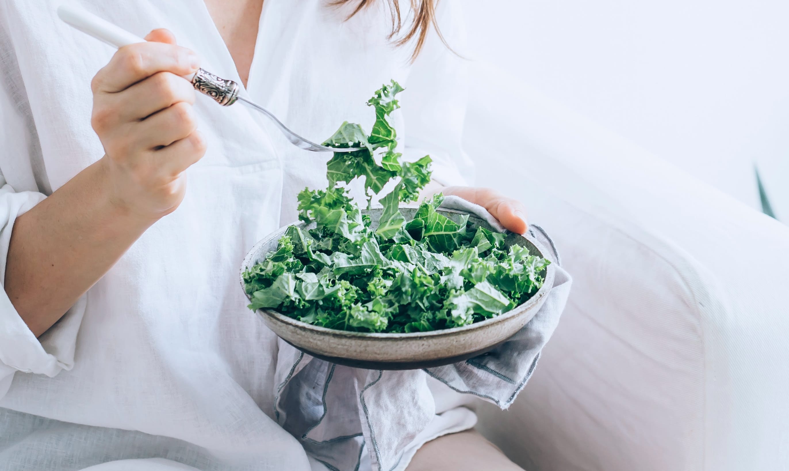 woman eating kale