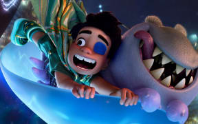 Elio, a young boy in an animation movie, flying on a board with an alien creature called Glordon.