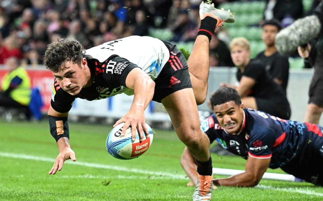Crusaders winger Macca Springer scores a try against the Melbourne Rebels.