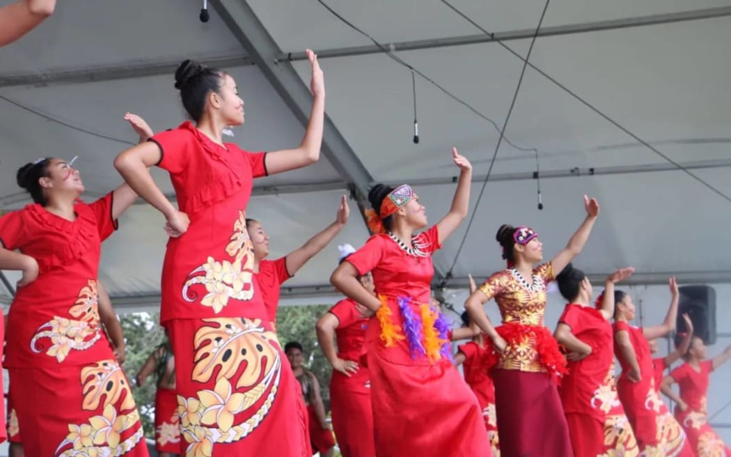 Woman dancing at an event in Auckland.