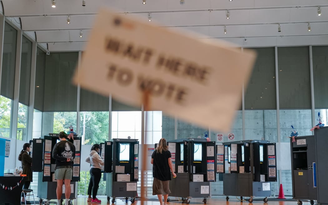 Voters cast their ballots on the last day of early voting at the High Museum of Art in Atlanta, Georgia, on November 1, 2024. (Photo by Elijah Nouvelage / AFP)