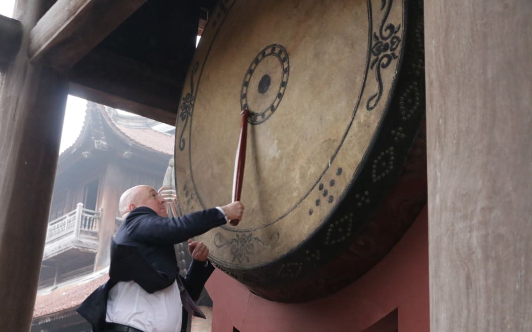 Prime Minister Christopher Luxon beats the drum during his visit to Hanoi, Vietnam on 27 February 2025.