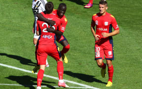 Adelaide United players celebrate a goal.
