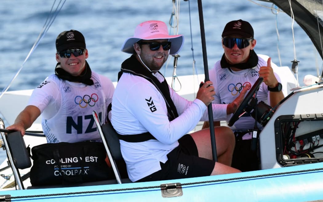 New Zealand's Isaac Mchardie and New Zealand's William Mckenzie react on the return boat after Race 1 of the men’s 49er skiff event during the Paris 2024 Olympic Games sailing competition at the Roucas-Blanc Marina in Marseille on July 28, 2024. (Photo by Christophe SIMON / AFP)