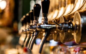 Beer taps in a bar.