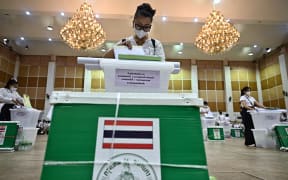 Election Commission volunteers inspect ballots and voting materials for distribution to polling booths in Bangkok on May 13, 2023, on the eve of the Thailand General election. (Photo by Lillian SUWANRUMPHA / AFP)