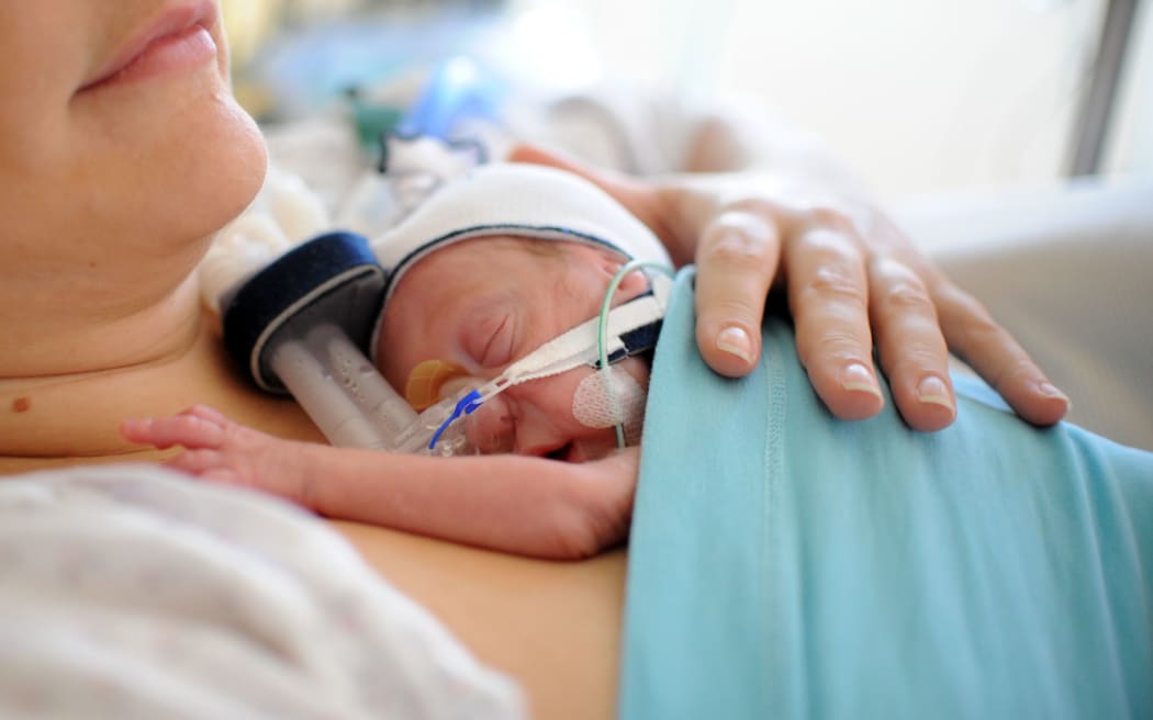 A mother with her premature newborn son.