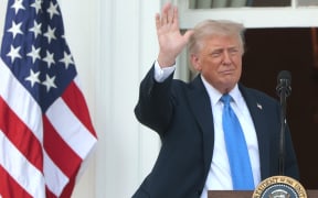 US President Donald Trump waves to guests from South Portico of the White House during an event on the South Lawn on 4 June, 2025 in Washington, DC.