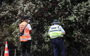 Police with iwi support at a checkpoint on SH1 at Uretiti. It is one of two new short-term checkpoints for northbound traffic set up as the Auckland region boundary opened.