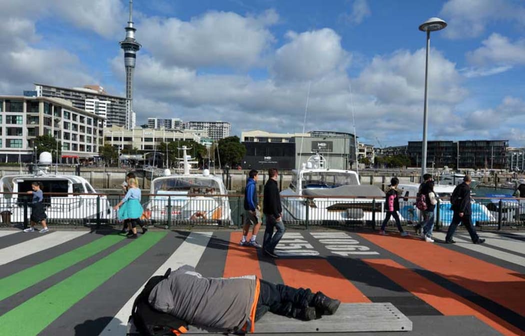 A man sleeps rough on Auckland's waterfront.