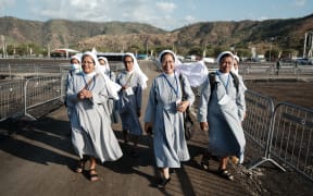 Indonesian sisters living in East Timor walk on the Esplanade of Taci Tolu, where Pope Francis will lead a mass, ahead of his visit in Dili on September 7, 2024. (Photo by Yasuyoshi CHIBA / AFP)