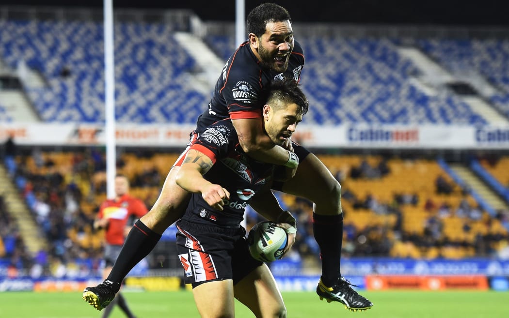 Konrad Hurrell rides the try scorer Shaun Johnson.