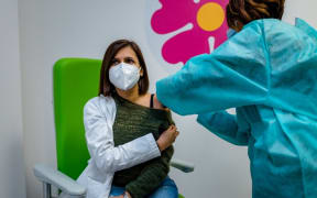 A doctor who works in the vaccination hub is given the third dose of the anticovid vaccine at the Cozzoli vaccine hub in Molfetta on November 24, 2021.