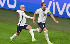 England's forward Harry Kane (R) celebrates after scoring the second goal during the UEFA EURO 2020 semi-final football match between England and Denmark at Wembley Stadium in London