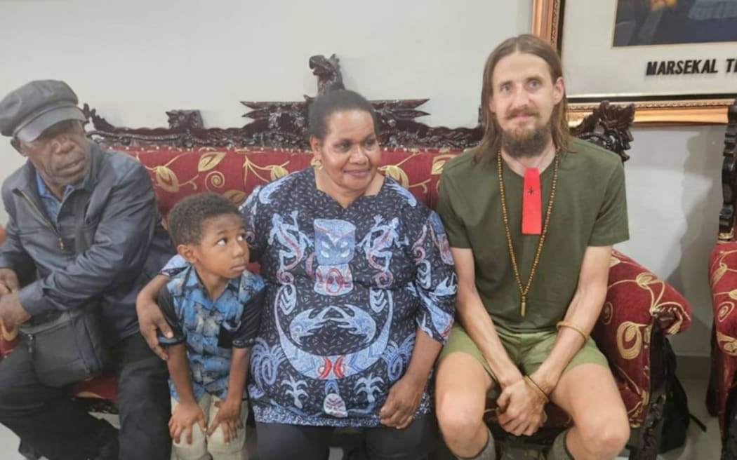 Former Acting Regent of Nduga, Edison Nggwijangge, far left, with Susi Air Pilot Phillip Mehrtens, right, after his release.