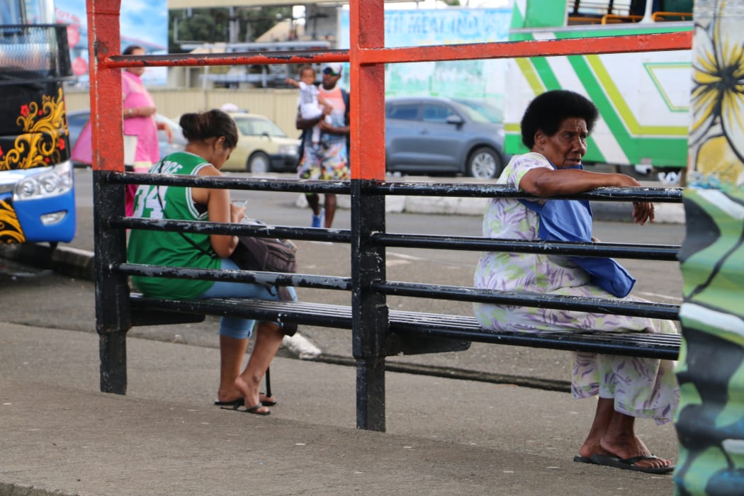 Women at the bus stop in Suva, Fiji