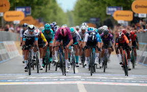 Lidl-Trek's Danish rider Mads Pedersen (C) sprints to the finish line to win the  3rd stage of the 108th Giro d'Italia cycling race. New Zealander Corbin Strong of Israel Premier Tech (right) finished second.