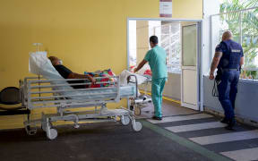 Medical staff workers take patients in charge in a triage area outside the emergency care unit of the Centre Hospitalier de Polynesie Francaise (CHPF) hospital, in Pirae, near Papeete