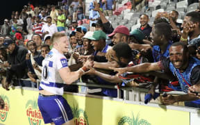 PNG crowd embrace Bulldogs prop Dylan Napa at the historical trial match held in Port Moresby.