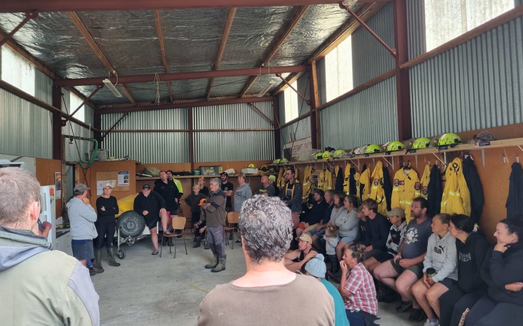 A meeting at the Putorino Fire Station three days after cyclone. Max Tweedie says they punched through slips to connect people together.