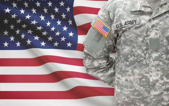 American soldier with flag on background - United States