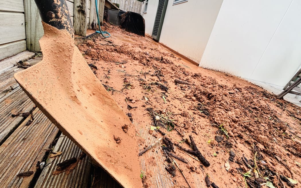 Mud and debris outside a home in Ōakura.
