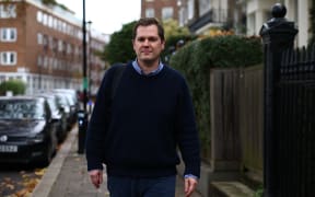 Britain's former Minister of State for Immigration, Robert Jenrick walks along a street near his home in central London, on December 7, 2023, following his resignation the previous evening. Britain's ruling Conservative party was in disarray Wednesday after its immigration minister quit over legislation regarding sending migrants to Rwanda as hardliners turned the screw on Prime Minister Rishi Sunak. (Photo by HENRY NICHOLLS / AFP)